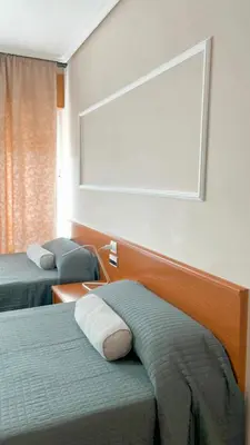 a hotel room with two beds and a window at Casa Pazos, Pedrafita do Cebreiro in Piedrafita