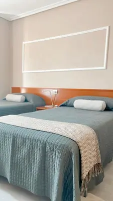 a bedroom with two beds and a window at Casa Pazos, Pedrafita do Cebreiro in Piedrafita