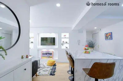 a white room with a table and a mirror at A-Entire Apartament 1 Minute From The Historical Center in Santiago de Compostela