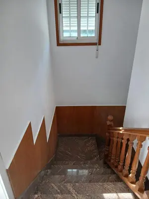 a bedroom with a bed and a large window at Casa Pucho Castroverde in Barreiros