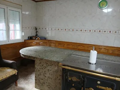 a kitchen with an island with a candle on it at Casa Pucho Castroverde in Barreiros
