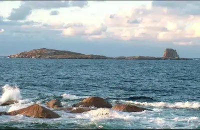 an island in the ocean with rocks in the water at EnSAN CIPRIAN Con Vistas Al Mar in Cervo