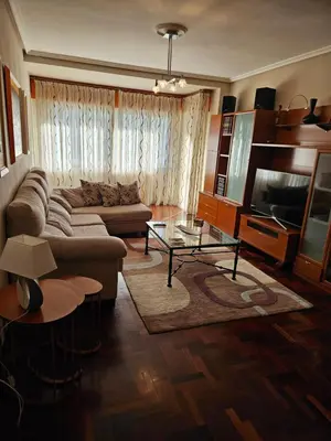 a living room with a couch and a tv at EL Descanso in Ourense