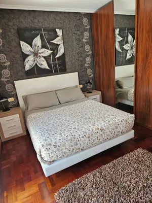 a white bed with two pillows on it in a bedroom at EL Descanso in Ourense