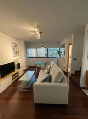 a living room with a white couch and a table at Viorneira in Milladoiro