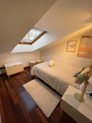 a bedroom with a bed and a window in it at Viorneira in Milladoiro
