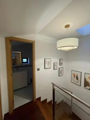a hallway with a staircase with a light and a ceiling at Viorneira in Milladoiro