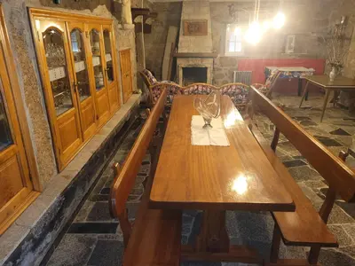 a long wooden table in a room with benches at Casa de López