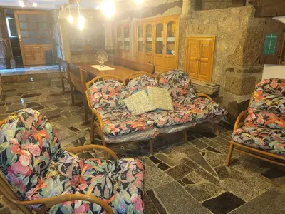 a living room with couches and a table and chairs at Casa de López