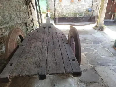 a wooden bench sitting next to a building at Casa de López