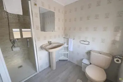 a bathroom with a toilet and a sink and a shower at Casa Rural Nito - Naturaleza y Descanso en Asturias in Villayón