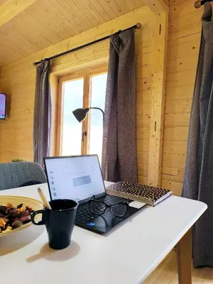 a laptop computer sitting on a white table at Cabaña de madera Mar y Madera, playa de las catedrales in Barreiros