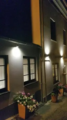 two potted plants on the side of a building at night at Casa De Aldea La Galea in Vegadeo