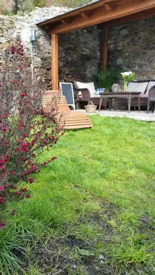 a garden with a patio with benches and flowers at Casa De Aldea La Galea in Vegadeo