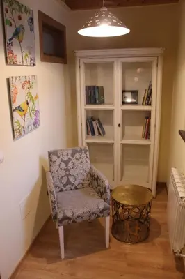 a room with a chair and a book shelf at Casa De Aldea La Galea in Vegadeo