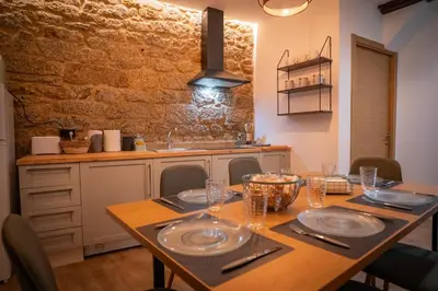 a kitchen with a wooden table with plates on it at A Torna in Palas de Rei