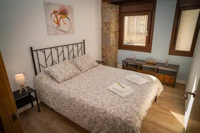 a bedroom with a bed with two towels on it at A Torna in Palas de Rei