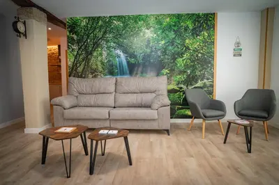 a living room with a couch and two chairs at A Torna in Palas de Rei