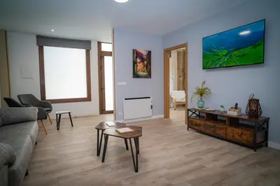 a living room with a couch and a table at A Torna in Palas de Rei