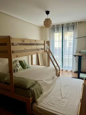 a bedroom with two bunk beds and a window at Costa Reinante Spa in San Miguel de Reinante