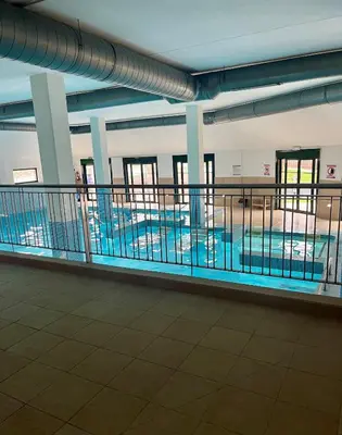 a large swimming pool in a building at Costa Reinante Spa in San Miguel de Reinante