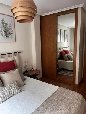 a bedroom with a large bed and a mirror at Costa Reinante Spa in San Miguel de Reinante