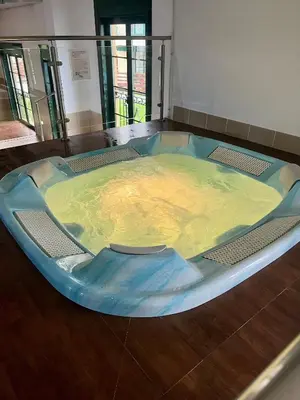 a large hot tub sitting on a wooden floor at Costa Reinante Spa in San Miguel de Reinante