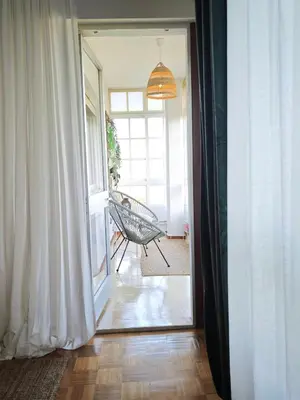 a hallway with a door open to a room with a bench at O Retiro de Bernardo in Teo