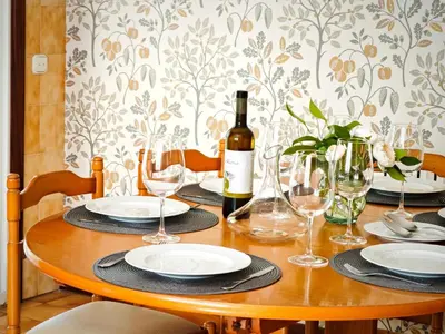 a wooden table with a bottle of wine and glasses at O Retiro de Bernardo in Teo