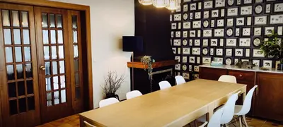 a dining room with a wooden table and white chairs at O Retiro de Bernardo in Teo