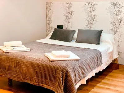 a bedroom with a bed with two towels on it at Hostal Restaurante MarRojo Sanabria in Requejo