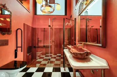 a bathroom with a toilet and a sink and a shower at Glam Taoo Hotel Apartamento Boutique in Lugo