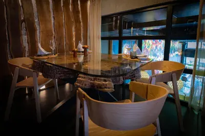 a dining room with a table and two chairs at Glam Taoo Hotel Apartamento Boutique in Lugo