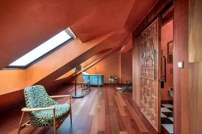 an attic room with a skylight and a chair at Glam Taoo Hotel Apartamento Boutique in Lugo