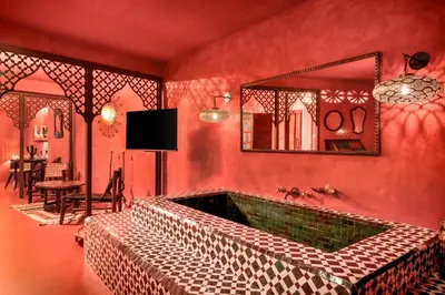 a red room with a large tub with a mirror at Glam Taoo Hotel Apartamento Boutique in Lugo