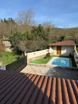 a patio with a table and chairs and a bath tub at A Casa da aldea de Iria in Padrón