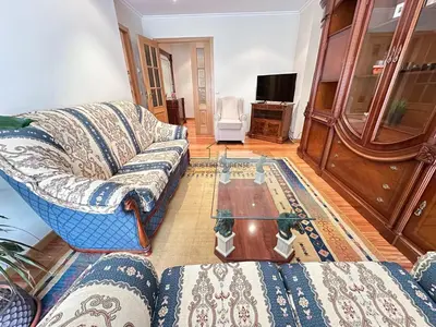 a living room with a couch and a glass table at Parque Ávila in Ourense