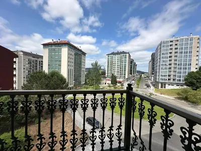 a view of a city from a balcony with buildings at Parque Ávila in Ourense