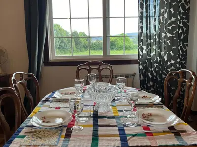 a table with plates and glasses on it with a window at Casa María in Santa Eulalia