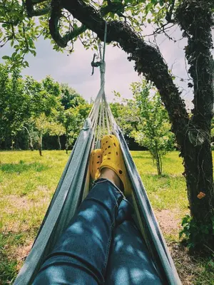 a person laying in a hammock with their foot in a tree at Casa María in Santa Eulalia