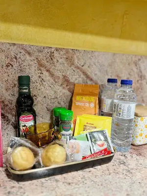 a tray with some food on a counter with bottles of water at Casa María B in Santa Eulalia
