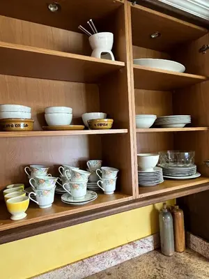 a shelf with plates and bowls on it at Casa María B in Santa Eulalia