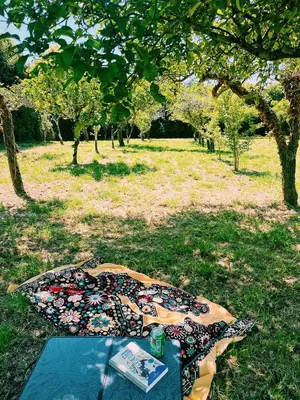 a sunset over a field with a table and chairs at Casa María B in Santa Eulalia