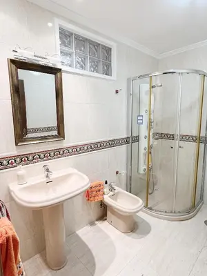 a bathroom with a sink and a shower and a toilet at Casa María B in Santa Eulalia