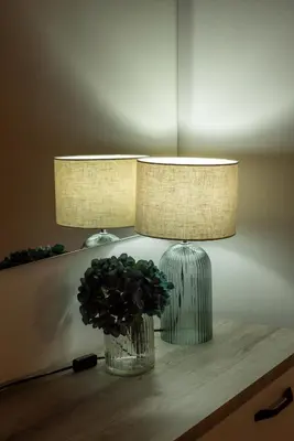 a lamp and a vase with a plant on a table at Villa Limia