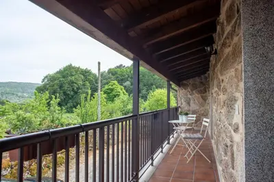 a balcony with a table and chairs on it at Villa Limia