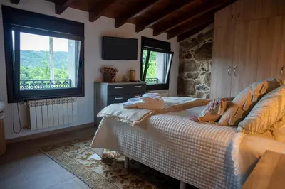 a bedroom with a bed and a tv and a window at Villa Limia