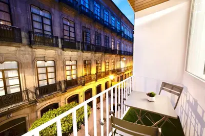 a balcony with a table and chairs in front of a building at Urban Essences by Lugo Collection in Lugo