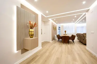 a living room with a table and a vase on the wall at Urban Essences by Lugo Collection in Lugo