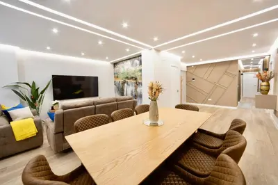 a living room with a wooden table and chairs at Urban Essences by Lugo Collection in Lugo